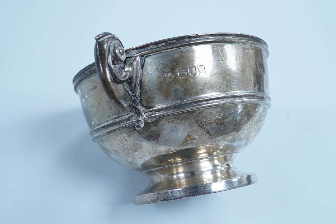 An Edwardian silver two handled pedestal bowl, by Lambert & Co, London, 1909, with later engraved inscription, diameter 10.5cm excluding the handles, 7.2oz.